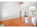 Spacious living room with wood floors, soaring ceilings, and arched entryways, perfect for entertaining at 3917 Erskine Woods Dr, Bessemer City, NC 28016