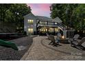 Beautiful backyard features a cozy fire pit area perfect for outdoor entertaining and relaxation at 402 Wildlife Rd, Troutman, NC 28166
