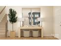 Bright entryway with modern console table, stylish lamps, decorative mirrors, and a staircase at 4247 Skyboat Cir, Fort Mill, SC 29715