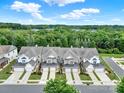 Aerial view of townhomes with driveways, garages, and lush trees at 45008 Wigeon Ln # 202, Indian Land, SC 29707