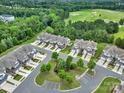 Aerial view showcasing townhomes and a scenic golf course in a lush, green neighborhood at 45008 Wigeon Ln # 202, Indian Land, SC 29707