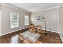 Cozy office with hardwood floors, two windows, neutral walls, and modern decor at 4637 Shannamara Dr, Matthews, NC 28104