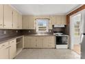 Functional kitchen with cream-colored cabinetry, laminate countertops, and essential appliances at 5170 Woodleaf Rd, Salisbury, NC 28147