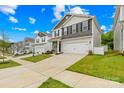 Street view of gray, two-story house with landscaped front yard and wide driveway at 5204 Belstone Ln, Charlotte, NC 28215