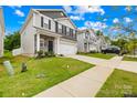 Street view of a gray, two-story house with a well-maintained lawn at 5204 Belstone Ln, Charlotte, NC 28215