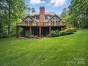 Lush backyard with a deck featuring a brick support structure and outdoor space, perfect for relaxing at 550 Burrage Ne Rd, Concord, NC 28025