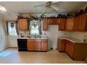Functional kitchen with wood cabinets and a view to the outside, ideal for meal prep and casual dining at 6000 Amberly Ln, Charlotte, NC 28213