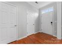 Bright entryway with hardwood floors, white doors, and a large window providing natural light at 6309 Margaret Ct, Indian Trail, NC 28079