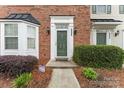 A welcoming front entrance with a green door and decorative black sconces at 6309 Margaret Ct, Indian Trail, NC 28079