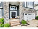 Inviting front porch with stone columns and space for seating, leading to the home's entrance at 645 Brookhaven Dr, Fort Mill, SC 29708