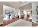Open-concept living room with hardwood floors, elegant staircase, and a view to the dining area at 645 Brookhaven Dr, Fort Mill, SC 29708