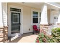 Inviting front porch with decorative door, stone accents, and comfortable seating at 7414 Meridale Forest Dr, Charlotte, NC 28269