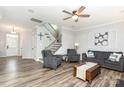 Bright living room with hardwood floors, neutral paint, and ample seating at 7414 Meridale Forest Dr, Charlotte, NC 28269