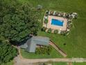 Aerial view of home with pool surrounded by lush greenery at 7660 Bud Davis Rd, Vale, NC 28168