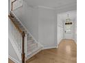 Inviting foyer with hardwood floors, staircase, coat hooks, and decorative light fixture at 809 Ayrshire Ave, Fort Mill, SC 29708