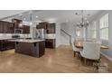 Open-concept kitchen with island, stainless steel appliances, and adjacent dining area at 809 Ayrshire Ave, Fort Mill, SC 29708