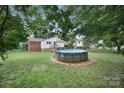 Backyard view features a large above ground pool and wooden deck, surrounded by mature trees at 842 Cherry S Rd, Rock Hill, SC 29732