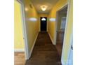 Inviting hallway with modern wood flooring and neutral wall colors leads to other areas of the home at 8720 Lee St, Mount Pleasant, NC 28124