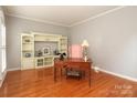 Cozy home office with hardwood floors, custom built-ins, and a vintage desk at 9900 Colvard Cir, Charlotte, NC 28269