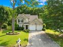 Charming two-story home with a well-maintained lawn, mature trees, and an inviting entrance at 10908 Delsing Ct, Charlotte, NC 28214