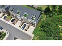 A bird's-eye view showing townhouses with rooftop terraces, lush landscaping, and ample parking at 11043 Stetler St, Charlotte, NC 28204