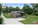 Two-story home featuring garage, covered porch, and well-maintained landscaping at 120 Pinewood Ln, Rock Hill, SC 29730