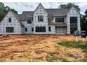 New home exterior in the process of being built with black windows and a construction yard at 1200 Andover Rd, Charlotte, NC 28211