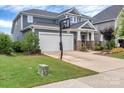 Beautiful home featuring a two-car garage, basketball area, well-kept lawn, and inviting front porch at 1230 Therns Ferry Dr, Fort Mill, SC 29708