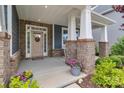 Inviting front porch with brick pillars, stylish decor, and ample space for seating and relaxation at 1230 Therns Ferry Dr, Fort Mill, SC 29708