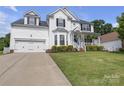 Charming two-story home with well-maintained lawn, neat landscaping, and welcoming front porch at 12303 Shadow Ridge Ln, Charlotte, NC 28273