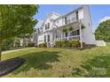 Charming home with a manicured lawn, stylish porch, and inviting curb appeal at 12303 Shadow Ridge Ln, Charlotte, NC 28273