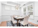 Bright dining room with modern chandelier, wooden table, and neutral tones, perfect for Gathering gatherings at 14923 Almondell Dr, Huntersville, NC 28078