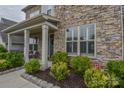 Inviting front porch with stone accents and well-maintained landscaping at 15216 Shallow Ridge Rd, Charlotte, NC 28278