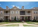 Inviting exterior view of townhomes with brick accents, balconies, and manicured lawn at 20216 Shaffer Bach Ln, Charlotte, NC 28277