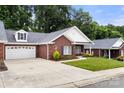Lovely brick home with a well-manicured lawn, attached garage, and inviting front entrance at 207 Crystal Springs Ln, Shelby, NC 28150