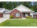 Beautiful brick home with a well-maintained lawn, attached garage, and appealing curb appeal at 207 Crystal Springs Ln, Shelby, NC 28150