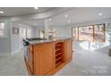 Spacious kitchen island with granite countertop, wine rack, and modern appliances at 2143 Manawa Ln, Tega Cay, SC 29708