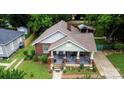 Aerial view of a brick home with a covered porch, manicured lawn, and detached garage at 224 E Steele St, Salisbury, NC 28144