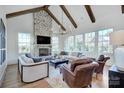 Bright living room with stone fireplace, wood beams, and large windows offering ample natural light at 2270 New Gray Rock Rd, Fort Mill, SC 29708