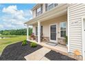 Inviting front porch with black mulch and stone accents, complete with a cozy seating area at 2340 Lanza Dr, Charlotte, NC 28215