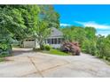 Exterior view of the home, highlighting its driveway, garage, and screened porch at 267 Ikerd Se Dr, Concord, NC 28025
