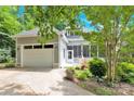 View of the house with its garage, driveway, and cozy porch at 267 Ikerd Se Dr, Concord, NC 28025
