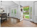 Elegant foyer featuring hardwood floors, wainscoting, and a view to the front yard at 2821 Providence Spring Ln, Charlotte, NC 28270