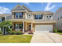 Charming brick and siding home with a two-car garage and manicured lawn at 3471 Melwood Estates Dr, Denver, NC 28037