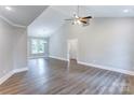 Spacious living room with wood-look floors, a vaulted ceiling, and neutral paint at 501 Old Speedway Nw Dr # 1, Concord, NC 28027