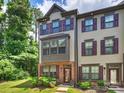 Charming townhome featuring detailed brickwork, a bay window, and neat landscaping at 513 Cubitt Ct, Charlotte, NC 28205