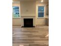 Bright living room features a cozy fireplace and large windows for natural light at 5239 Scotts Creek Rd, Indian Land, SC 29707