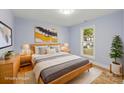 Cozy bedroom features a queen bed, modern decor, and plenty of natural light at 5414 Leaford Ct, Charlotte, NC 28227