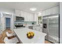 Modern kitchen with stainless steel appliances, white cabinets, and quartz countertops at 5414 Leaford Ct, Charlotte, NC 28227