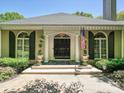 The property boasts a stylish black double door entry, framed by elegant columns and arched windows with shutters at 643 Baron Rd # 8, Waxhaw, NC 28173